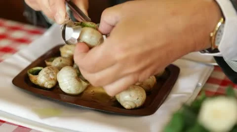 Man eating snails Video stock 12580754
