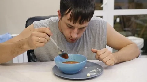 Man eating soup Stock Footage 68867981