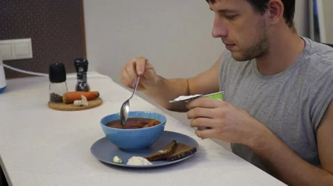 Man eating soup spoon Stock Footage 68868124