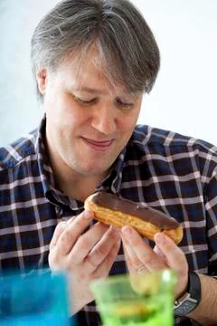 Man eating sweets Stock Photos