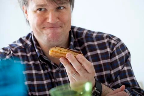 Man eating sweets Stock Photos