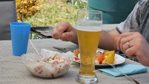 A man eating at a table and drinking beer Stock Footage 89676706