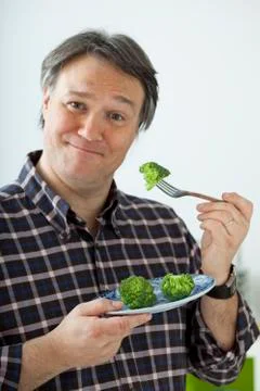 Man eating vegetable Stock Photos