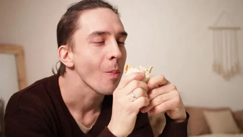 A man eats and enjoys food. Video stock 151590179