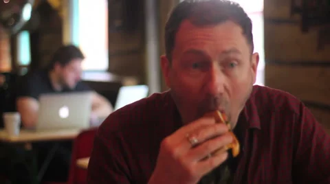 Man eats baguette in cafe Video stock 34344011