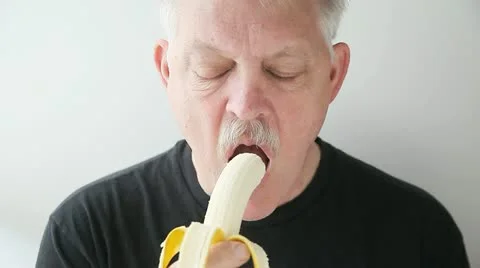 Man eats banana Stock Footage 22355768