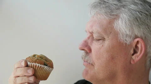 Man eats blueberry muffin Stock Footage 22663729