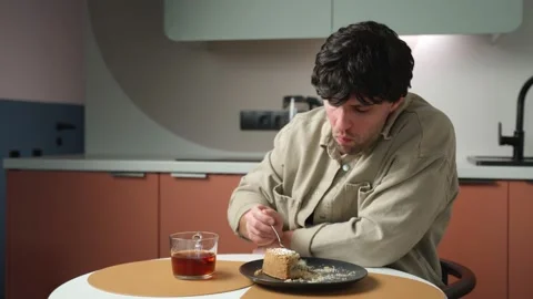 Man Eats A Cake And Drinks Tea For Break Stock Video Pond5