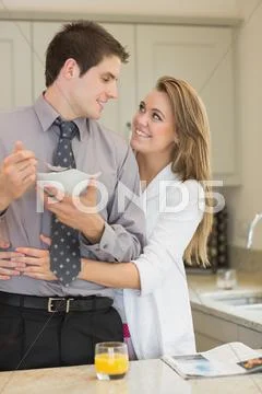 Man eats cereal while partner is embracing him Stock Photos