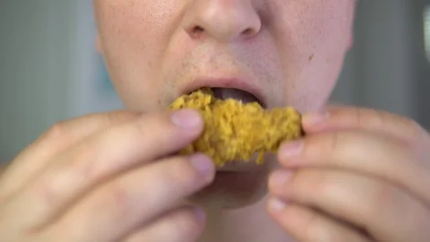 The man eats chicken wings. Stock Footage 89889126