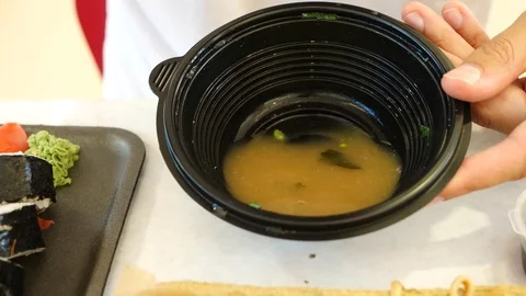 A man eats Chinese food in a fast food restaurant. 4k. Slow motion. Stock Footage