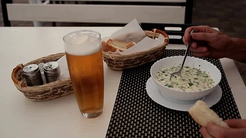 Man eats cold soup at white table Stock Footage 123624085