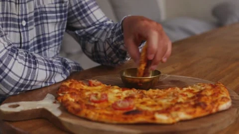 A man eats crispy pizza crusts with sauce. Stock Footage 267985519