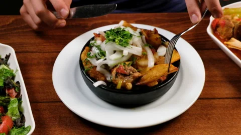 The man eats delicious food. Stewed meat with potatoes and onions. slow motion Stock Footage 283469490