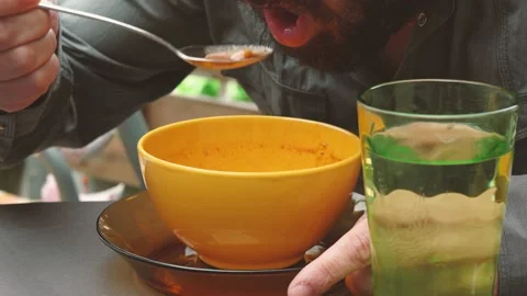 Man Eats a Delicious Soup of Tomato, Close-Up. Video stock 130504304