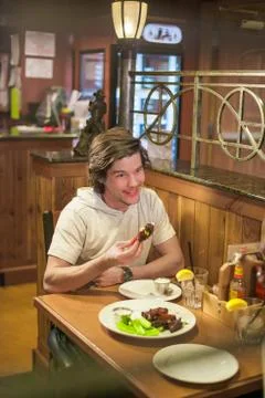 Man Eats Dinner Out with Date Stock Photos