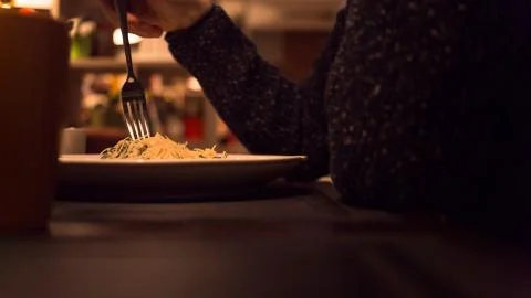 Man eats a dish with fork in restaurant Stock Photos