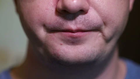 Man eats a donut in white glaze. close-up Stock-Footage 118324624