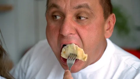A man eats dumplings Stock Footage 106184291
