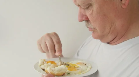 Man eats eggs and biscuit breakfast Stock Footage 39444021
