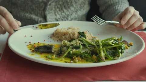 The man eats fish and rice with vegetables in cafe. Close up Stock Footage 86492580