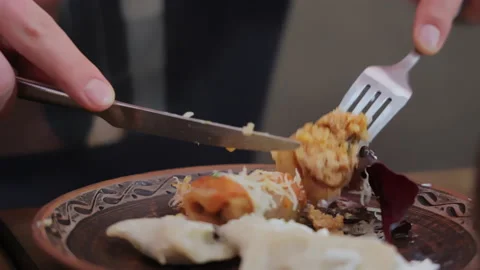 A man eats food with a fork from a plate close-up Stock Footage 237710103