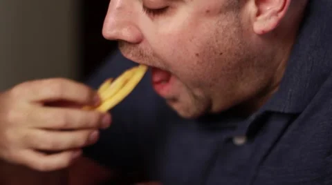 Man eats french fries Stock Footage 47148934
