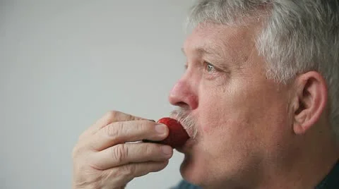 Man eats fresh strawberry Stock Footage 22358862