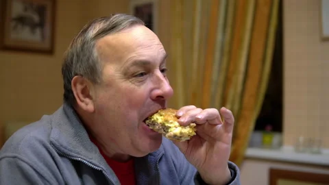 The man eats a hamburger and drinks soda. Man with hamburger at home. Stock Footage 145372122