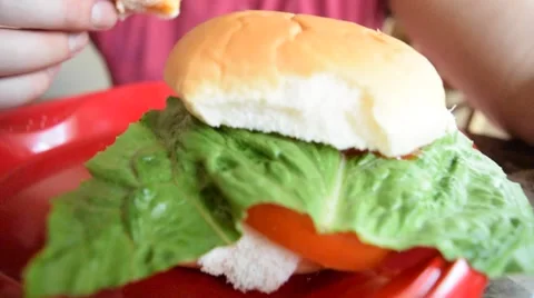 Man eats hamburger close up Stock Footage