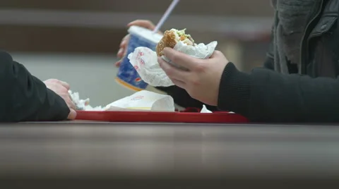 Man eats hamburger the other waits Video stock 47066941