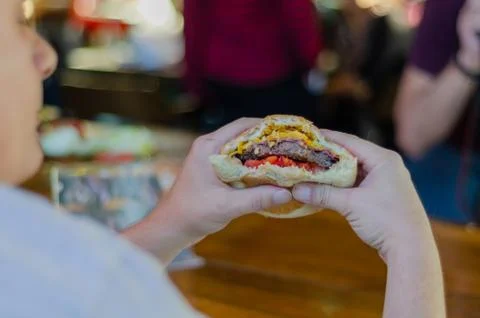 The man eats hamburger with pleasure. Foto stock