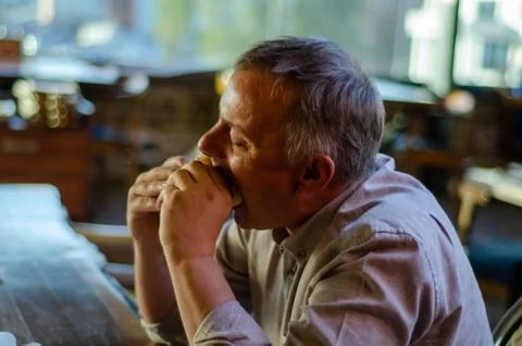 The man eats hamburger with pleasure. Foto stock