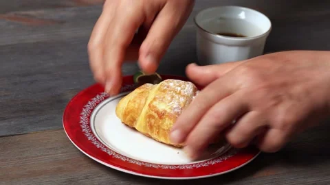 Man eats his croissant and coffee Stock Footage 137192664