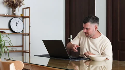 A man eats lunch without leaving his workstation. Stock Footage 310219402