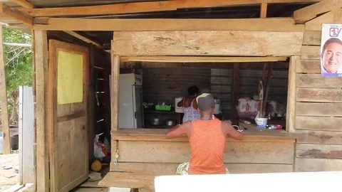 Man eats meal at a restaurant in a shack Stock Footage 111233860