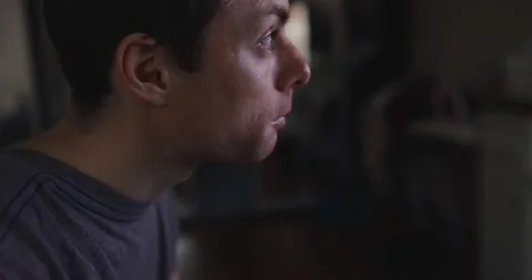 Man eats meat and watches tv at home Stock Footage 147556008