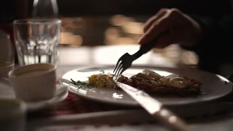 A man eats meat in a restaurant Close-up of a meal Stock Footage 150275651