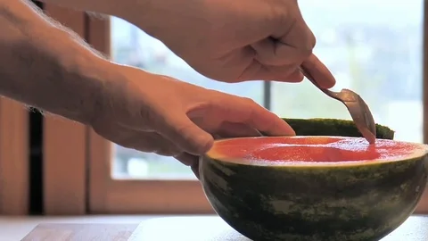 Man eats melon wirh a spoon Stock Footage 116908456