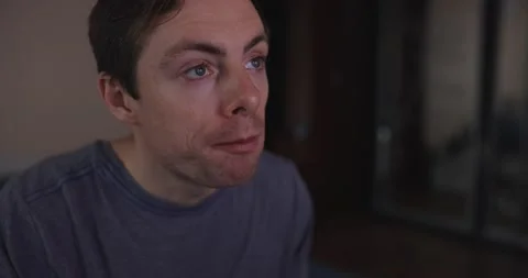 Man eats pasta and watches tv at home Stock Footage 147555975