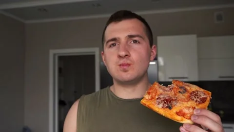Man eats pizza in front of the camera. 4k footage 스톡 동영상 156763058
