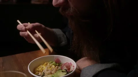 A man eats Poke in a cafe Stock Footage 223881611