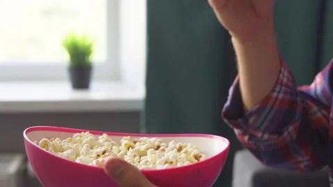 Man eats popcorn and watches tv. Stock Footage 219553202