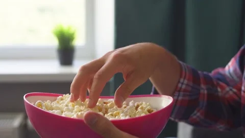 Man eats popcorn and watches tv. Stock Footage 221261252