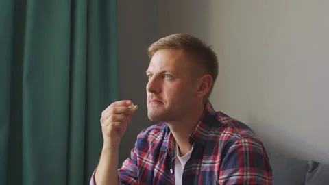Man eats popcorn and watches tv. Stock Footage 221398588