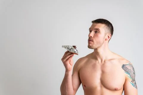 Man eats protein bar on white background isolated bar energy eat, eating health Foto stock