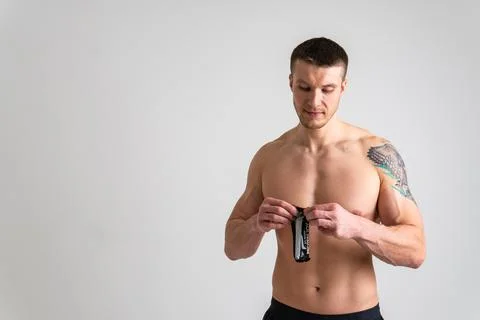 Man eats protein bar on white background isolated bar snack eating man natural Stock Photos