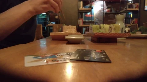 A man eats rolls in a restaurant. Background blurred Video stock 100452216
