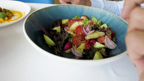 Man eats salad in a cafe, close up, vegetarian food Stock Footage 114302812
