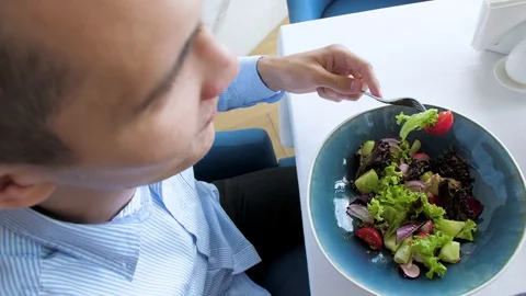 Man eats salad in a cafe, close up, vegetarian food Stock Footage 114307011